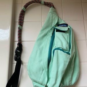 Kavu crossbody bag. Turquoise in color with multi-color strap